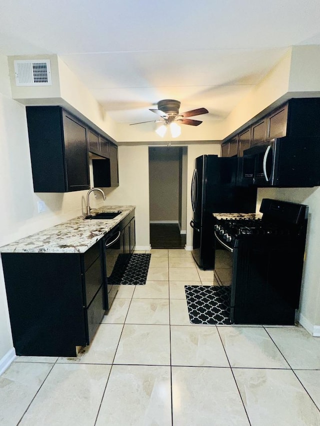 kitchen with black appliances, a sink, ceiling fan, light countertops, and light tile patterned floors