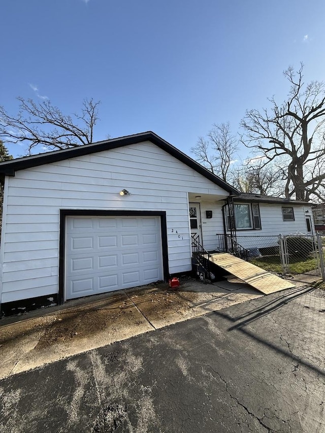 2401 24th St, North Chicago, IL 60064 - view of front facade with aphalt driveway and fence