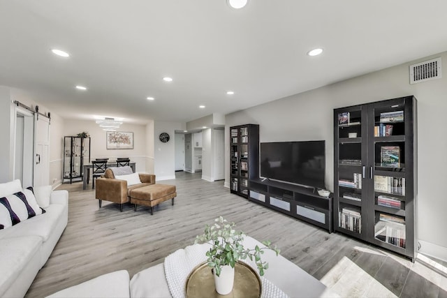 110 S Dunton Ave Unit 2C, Arlington Heights, IL 60005 - living room featuring a barn door, wood finished floors, recessed lighting, and baseboards