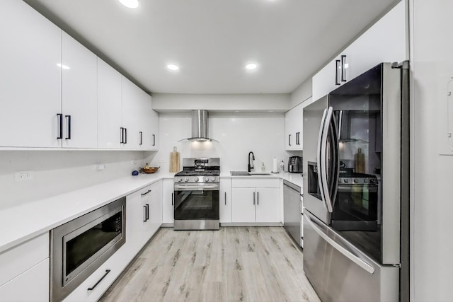 110 S Dunton Ave Unit 2C, Arlington Heights, IL 60005 - kitchen with appliances with stainless steel finishes, wall chimney range hood, a sink, light wood finished floors, and light countertops