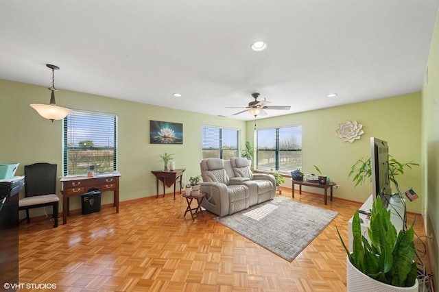 living room with baseboards, ceiling fan, and recessed lighting
