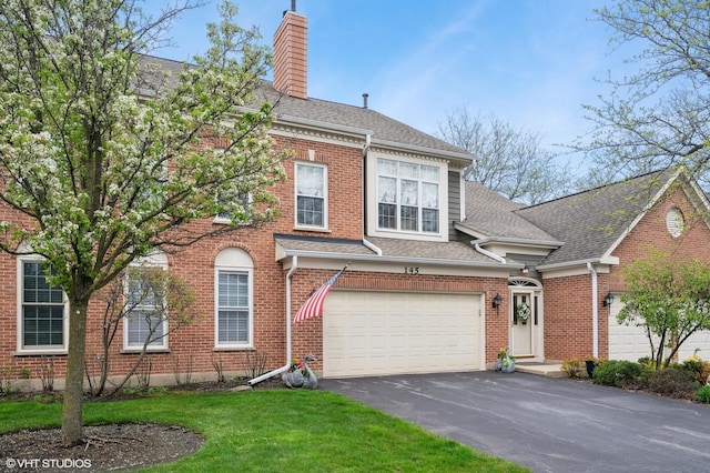 145 Princeton Ln, Glenview, IL 60026 - view of front facade featuring driveway, an attached garage, a chimney, a front yard, and roof with shingles