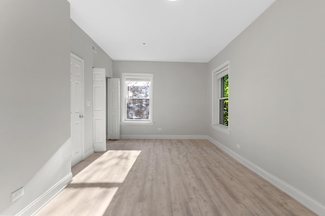 unfurnished bedroom with light wood-type flooring and baseboards