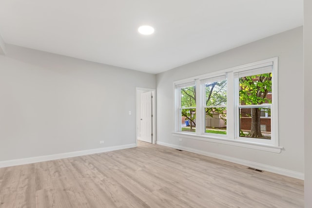 unfurnished room with light wood-style floors and baseboards