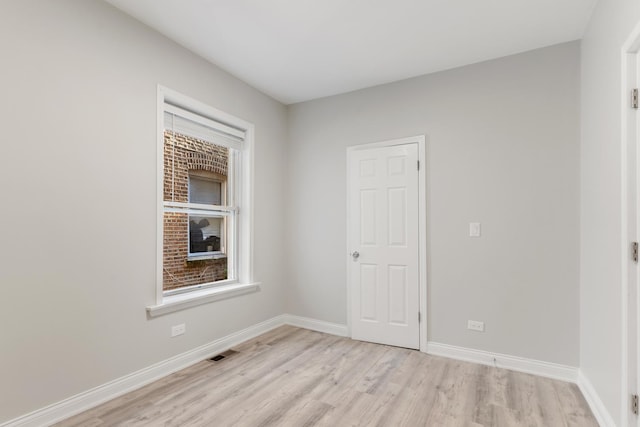 unfurnished room featuring light wood-style floors and baseboards