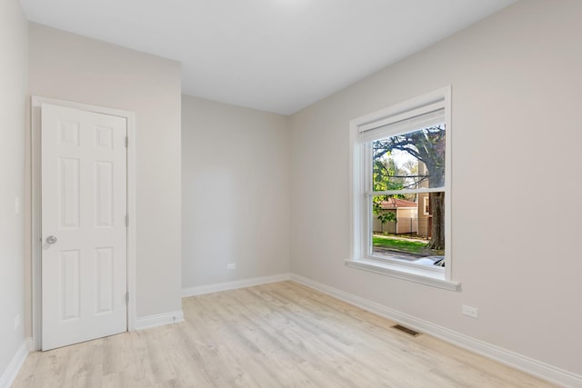 empty room featuring wood finished floors and baseboards