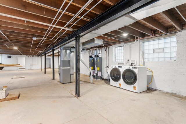 below grade area with washing machine and dryer, water heater, and heating unit