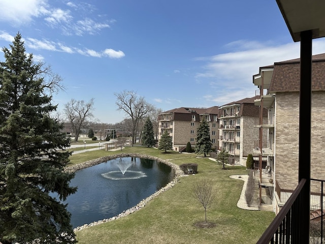 view of community with a water view and a lawn