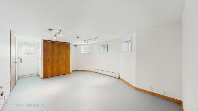 620 S Elmwood Ave, Oak Park, IL 60304 - spare room with rail lighting, visible vents, baseboard heating, baseboards, and concrete floors