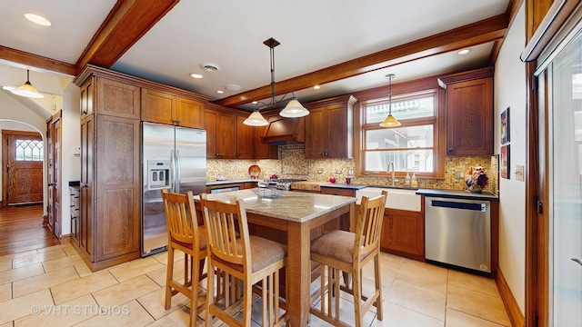 620 S Elmwood Ave, Oak Park, IL 60304 - kitchen featuring a healthy amount of sunlight, stainless steel appliances, beamed ceiling, and a sink