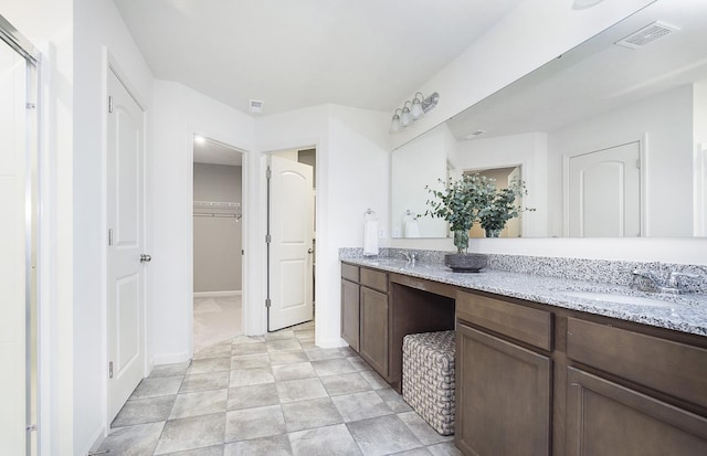 109 N Van Nortwick Ave, Batavia, IL 60510 - bathroom featuring double vanity, a walk in closet, and baseboards