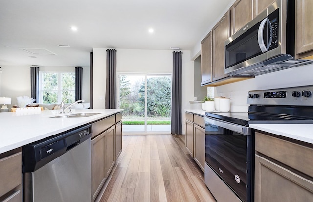 109 N Van Nortwick Ave, Batavia, IL 60510 - kitchen with stainless steel appliances, a sink, light wood-style flooring, light countertops, and recessed lighting