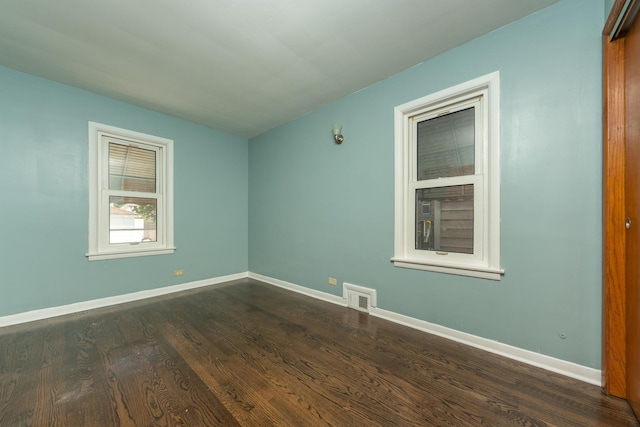 8007 S Houston Ave, Chicago, IL 60617 - unfurnished room with dark wood finished floors and baseboards