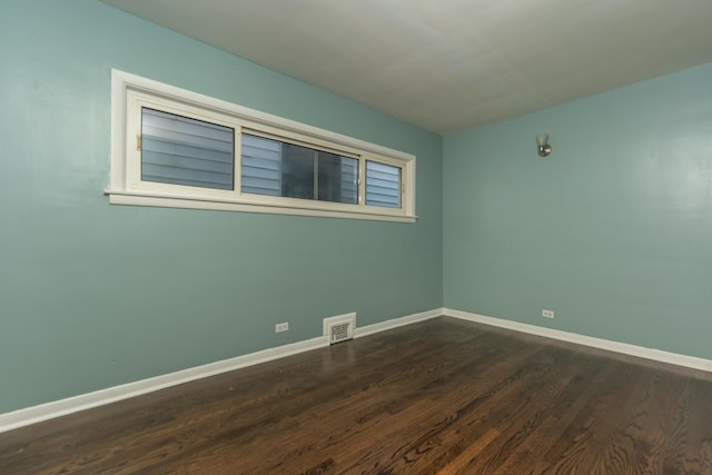 8007 S Houston Ave, Chicago, IL 60617 - empty room featuring dark wood finished floors and baseboards