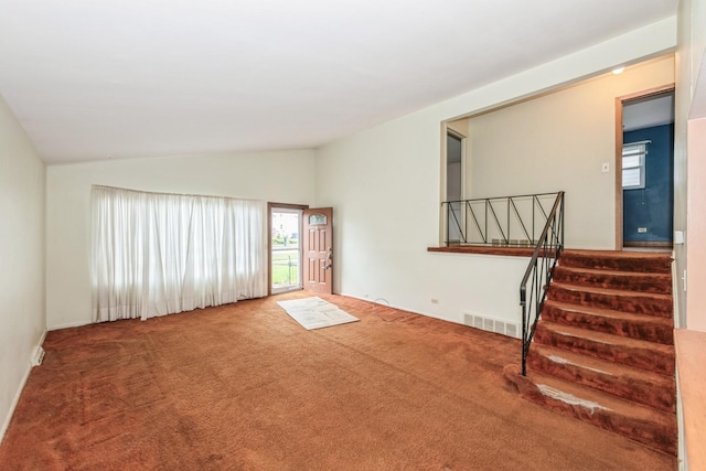 646 W Babcock Ave, Elmhurst, IL 60126 - unfurnished living room featuring vaulted ceiling, stairway, and carpet