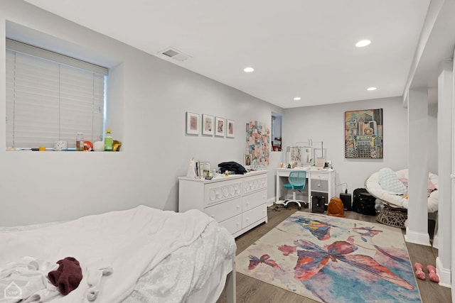 bedroom with recessed lighting, baseboards, visible vents, and wood finished floors