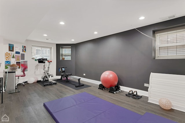 workout area with recessed lighting, baseboards, visible vents, and wood finished floors