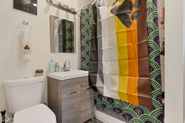 bathroom featuring toilet, a shower with curtain, and vanity