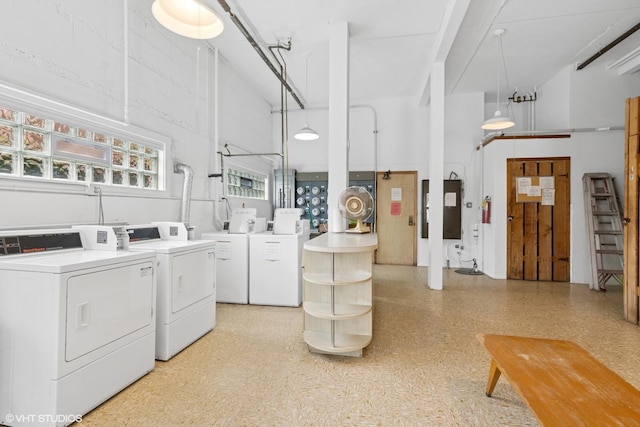 community laundry room with washer and clothes dryer