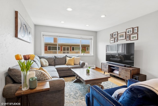 living room featuring wood finished floors, recessed lighting, and a baseboard heating unit