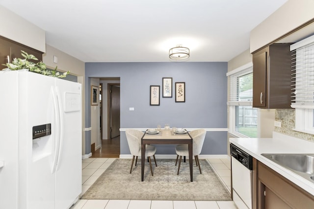 dining area featuring light tile patterned floors and baseboards