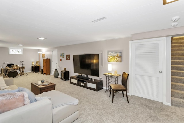 living area featuring stairs, carpet, and baseboards