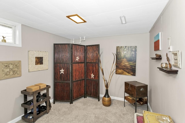 interior space featuring carpet and baseboards