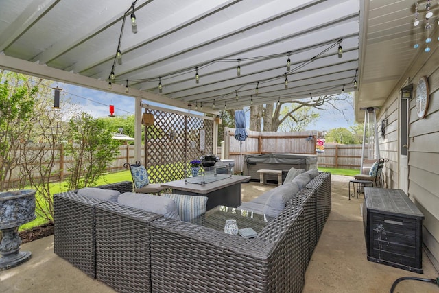 view of patio / terrace with a hot tub, an outdoor living space, and a fenced backyard