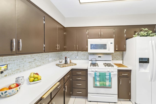 kitchen featuring white appliances, light countertops, dark brown cabinetry, and decorative backsplash