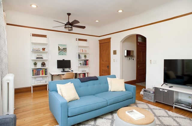 5338 S Greenwood Ave Unit 3, Chicago, IL 60615 - living area featuring radiator heating unit, arched walkways, a ceiling fan, wood finished floors, and recessed lighting