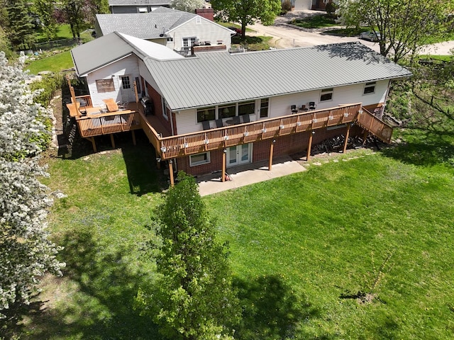 1612 Parkside Ct, Freeport, IL 61032 - rear view of property featuring a wooden deck, a yard, a patio area, and metal roof