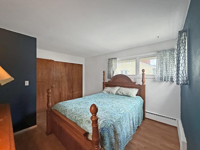 1612 Parkside Ct, Freeport, IL 61032 - bedroom featuring a closet, wood finished floors, baseboards, and a baseboard radiator