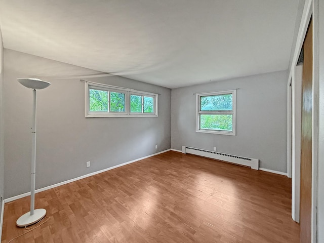 1612 Parkside Ct, Freeport, IL 61032 - unfurnished bedroom with a baseboard radiator, wood finished floors, and baseboards
