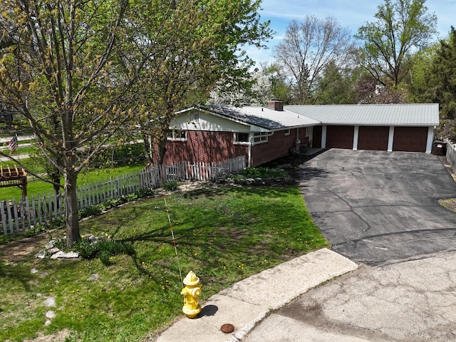1612 Parkside Ct, Freeport, IL 61032 - view of front of house featuring a chimney, driveway, and brick siding