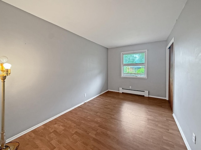 1612 Parkside Ct, Freeport, IL 61032 - spare room with a baseboard heating unit, wood finished floors, and baseboards