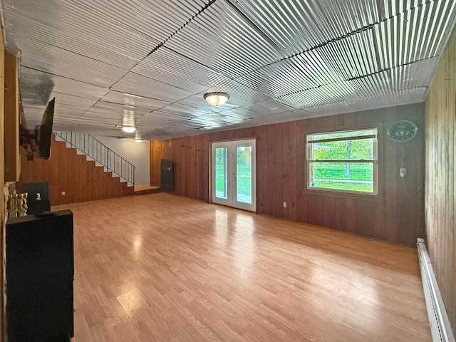 1612 Parkside Ct, Freeport, IL 61032 - below grade area featuring a baseboard heating unit, stairway, wood finished floors, wood walls, and ceiling fan