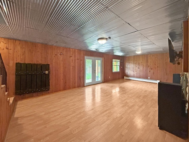 1612 Parkside Ct, Freeport, IL 61032 - unfurnished living room featuring a baseboard heating unit, wooden walls, and wood finished floors