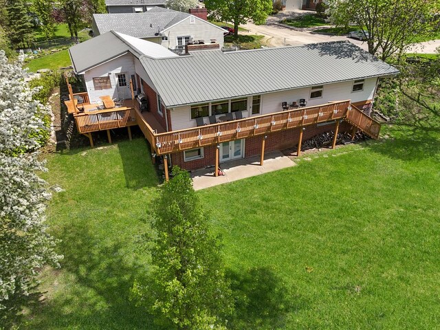 1612 Parkside Ct, Freeport, IL 61032 - back of property with a deck, a yard, a patio, metal roof, and brick siding