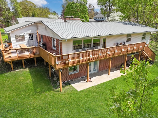 1612 Parkside Ct, Freeport, IL 61032 - back of house featuring a wooden deck, a patio, a lawn, metal roof, and a standing seam roof