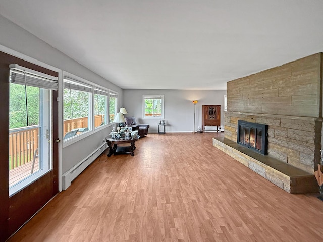 1612 Parkside Ct, Freeport, IL 61032 - living room featuring baseboard heating, wood finished floors, a fireplace, and baseboards