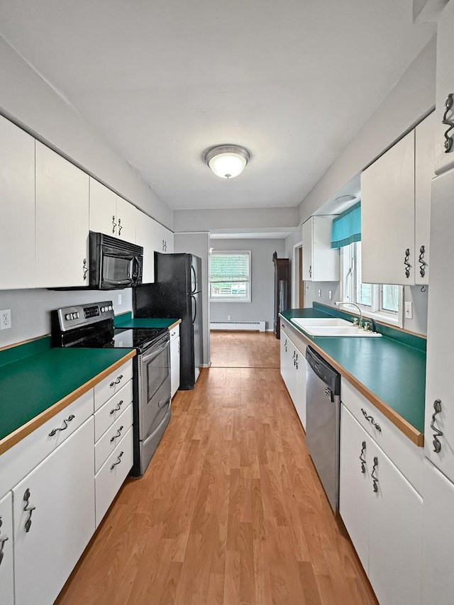 1612 Parkside Ct, Freeport, IL 61032 - kitchen with appliances with stainless steel finishes, light wood-style floors, white cabinets, and a baseboard heating unit