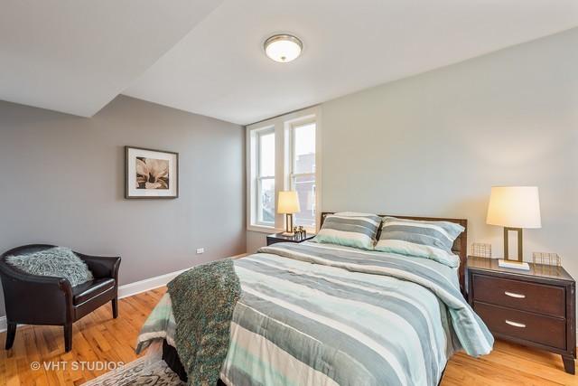 bedroom with light wood-type flooring and baseboards