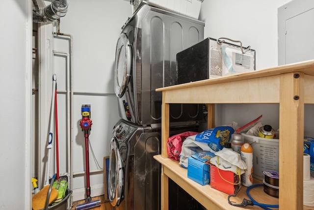 storage room featuring stacked washer and clothes dryer