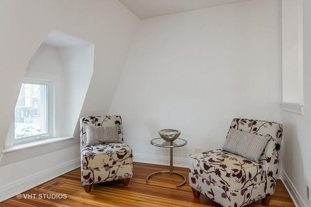 living area featuring wood finished floors and baseboards
