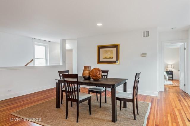 dining area with baseboards, light wood-style floors, and visible vents
