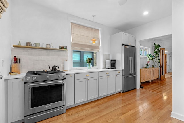 kitchen featuring appliances with stainless steel finishes, backsplash, light countertops, light wood-type flooring, and recessed lighting