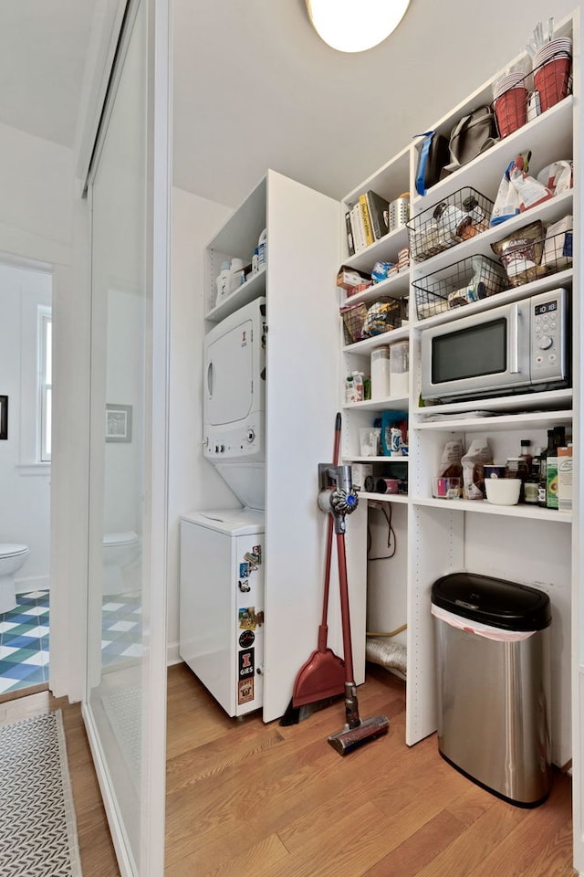 storage area featuring stacked washer / dryer