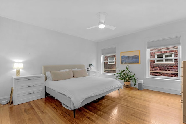bedroom featuring light wood-type flooring and ceiling fan