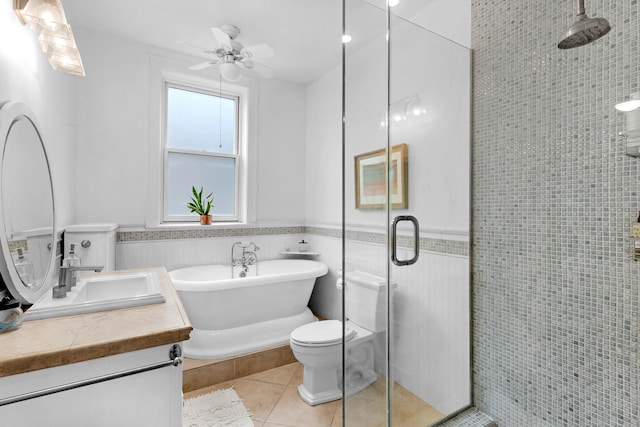 full bathroom featuring tile patterned floors, a stall shower, vanity, tile walls, and a soaking tub