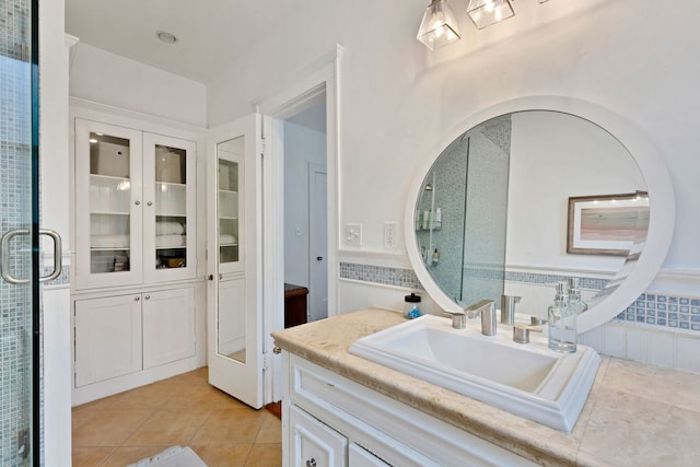 full bath with tile patterned flooring, vanity, and french doors